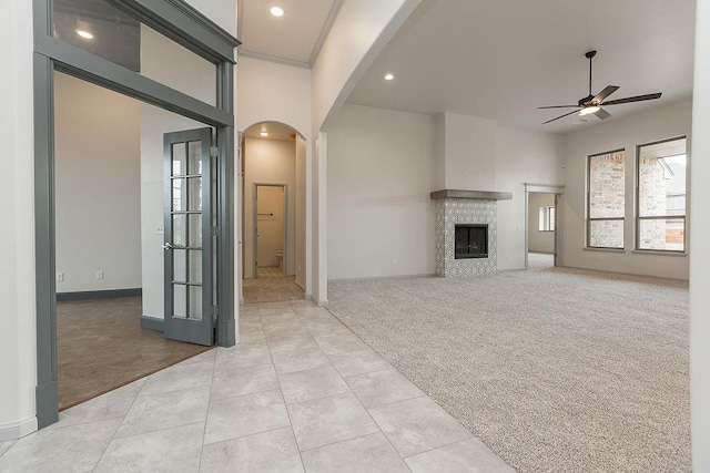 9120 SW 34th St, Oklahoma City, OK 73179 - unfurnished living room featuring arched walkways, a ceiling fan, light colored carpet, recessed lighting, and baseboards