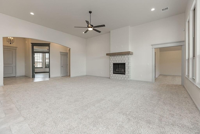 9120 SW 34th St, Oklahoma City, OK 73179 - unfurnished living room with a ceiling fan, a tile fireplace, baseboards, recessed lighting, and arched walkways