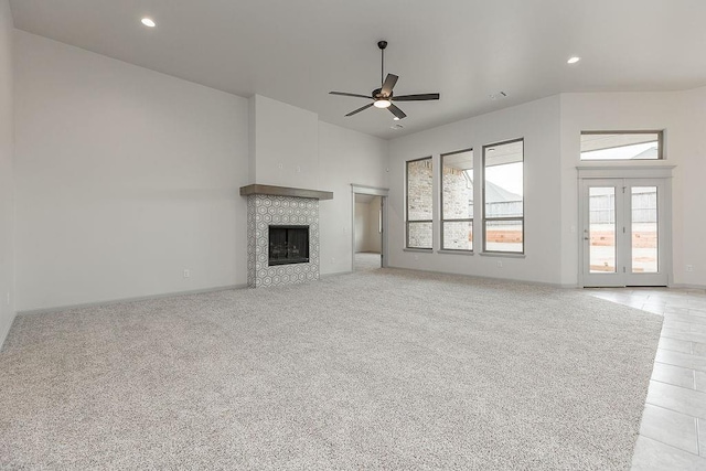 9120 SW 34th St, Oklahoma City, OK 73179 - unfurnished living room with a ceiling fan, a tiled fireplace, recessed lighting, baseboards, and light colored carpet