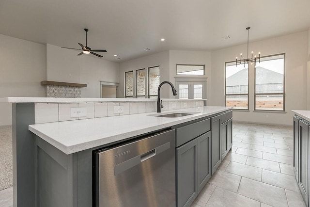 9120 SW 34th St, Oklahoma City, OK 73179 - kitchen featuring stainless steel dishwasher, a sink, gray cabinetry, a center island with sink, and light countertops