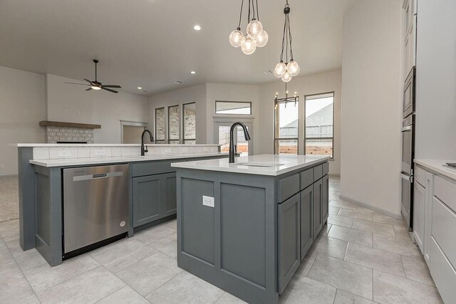 9120 SW 34th St, Oklahoma City, OK 73179 - kitchen with appliances with stainless steel finishes, gray cabinets, a center island with sink, a sink, and light countertops