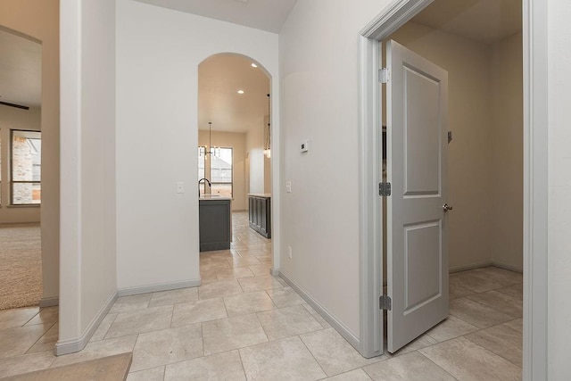9120 SW 34th St, Oklahoma City, OK 73179 - hallway featuring arched walkways, baseboards, light tile patterned floors, and recessed lighting