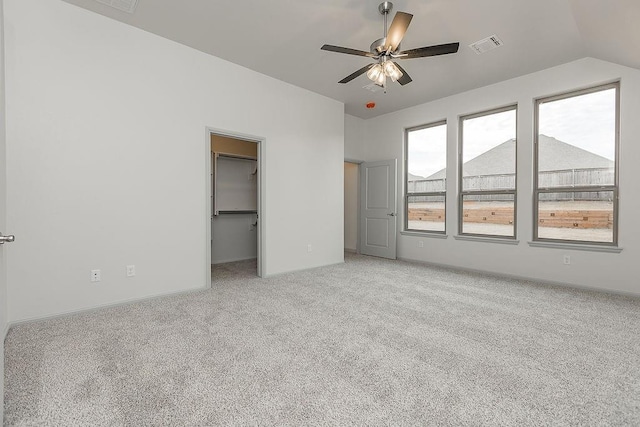 9120 SW 34th St, Oklahoma City, OK 73179 - unfurnished bedroom with light carpet, lofted ceiling, a walk in closet, a ceiling fan, and baseboards