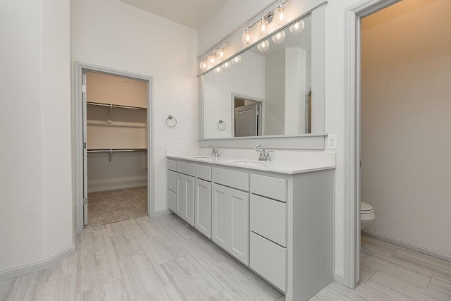 9120 SW 34th St, Oklahoma City, OK 73179 - full bath featuring toilet, double vanity, a spacious closet, and baseboards