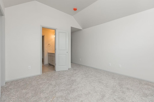 9120 SW 34th St, Oklahoma City, OK 73179 - unfurnished bedroom featuring lofted ceiling, light carpet, baseboards, and ensuite bathroom