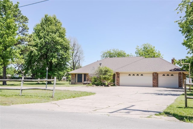 5624 N Mueller Ave, Bethany, OK 73008 - view of front facade with driveway, a garage, and brick siding