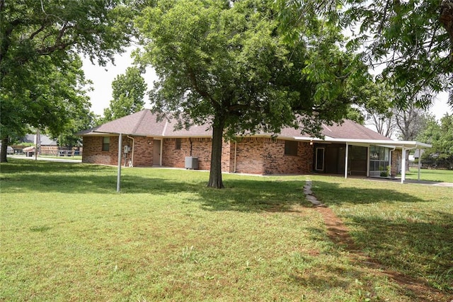 5624 N Mueller Ave, Bethany, OK 73008 - rear view of property featuring a lawn, brick siding, and an attached carport