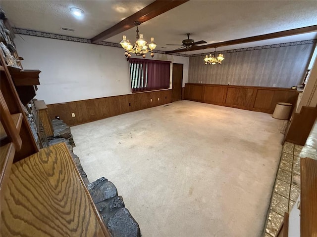 5624 N Mueller Ave, Bethany, OK 73008 - spare room with a chandelier, wainscoting, wood walls, beam ceiling, and carpet flooring