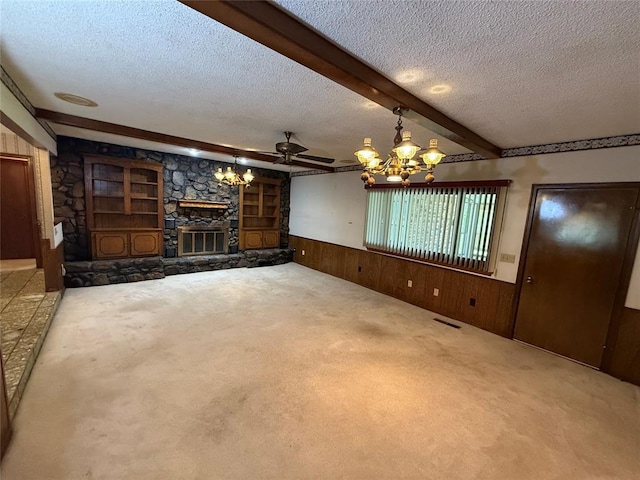 5624 N Mueller Ave, Bethany, OK 73008 - unfurnished living room with a textured ceiling, beam ceiling, wooden walls, a wainscoted wall, and a chandelier