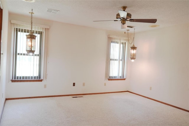 5624 N Mueller Ave, Bethany, OK 73008 - carpeted spare room with ceiling fan and a textured ceiling
