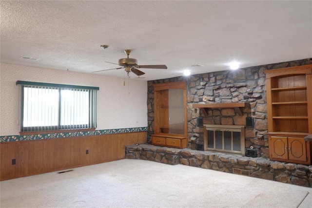 5624 N Mueller Ave, Bethany, OK 73008 - living room with a wainscoted wall, a textured ceiling, carpet, ceiling fan, and wood walls