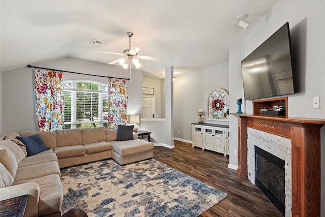 4125 Queens Dr, Moore, OK 73160 - living area with a ceiling fan, a stone fireplace, wood finished floors, vaulted ceiling, and baseboards