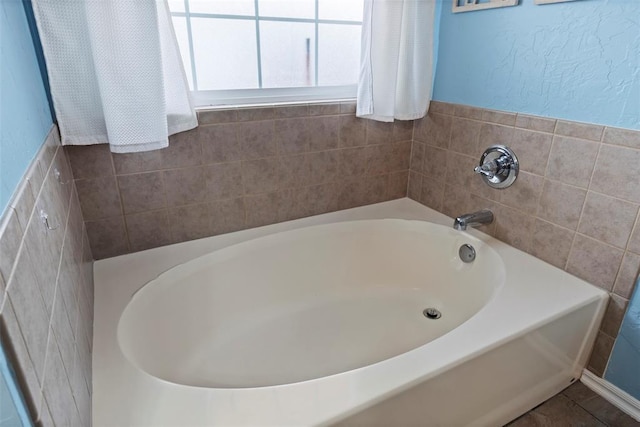 4125 Queens Dr, Moore, OK 73160 - bathroom featuring a garden tub and tile walls