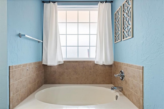 4125 Queens Dr, Moore, OK 73160 - full bathroom with a garden tub and a textured wall