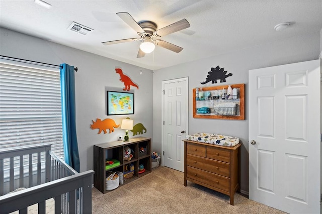 4125 Queens Dr, Moore, OK 73160 - bedroom featuring light carpet, a nursery area, and ceiling fan