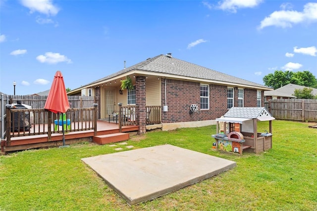 4125 Queens Dr, Moore, OK 73160 - back of property with a patio area, brick siding, and a wooden deck
