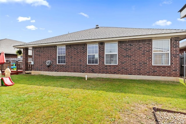 4125 Queens Dr, Moore, OK 73160 - back of house featuring brick siding, a lawn, and a shingled roof