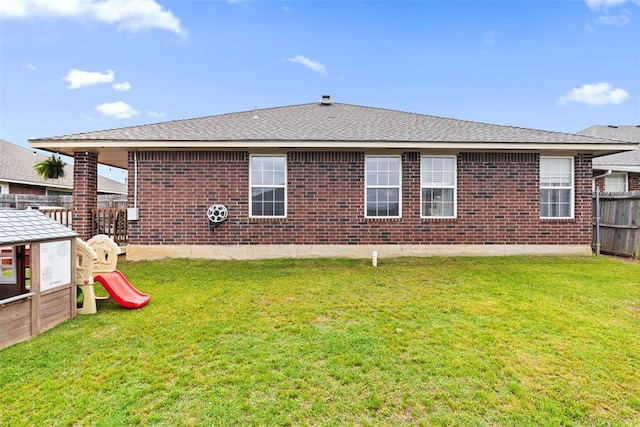4125 Queens Dr, Moore, OK 73160 - rear view of property featuring brick siding, a playground, and roof with shingles