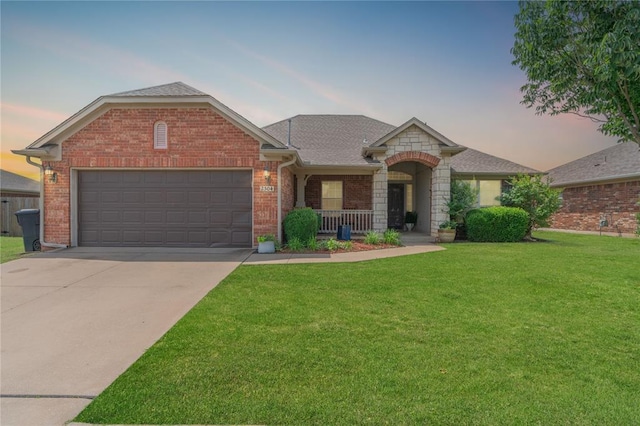 2504 NW 180th St, Edmond, OK 73012 - view of front of property featuring a front lawn, brick siding, a garage, and driveway