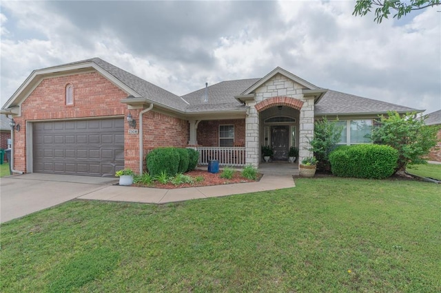 2504 NW 180th St, Edmond, OK 73012 - view of front of home with brick siding, a garage, a front yard, covered porch, and concrete driveway