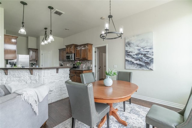 2504 NW 180th St, Edmond, OK 73012 - dining space with a chandelier, dark wood-style flooring, and baseboards