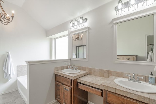 2504 NW 180th St, Edmond, OK 73012 - full bath with a chandelier, vaulted ceiling, double vanity, a tub, and tile patterned floors