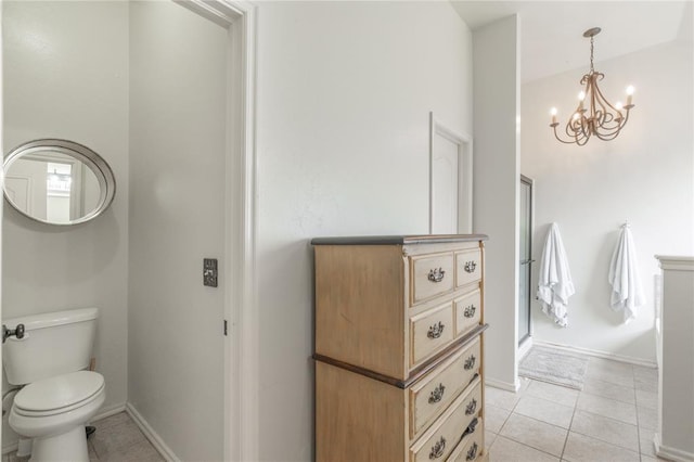 2504 NW 180th St, Edmond, OK 73012 - bathroom with tile patterned flooring, a chandelier, toilet, and baseboards