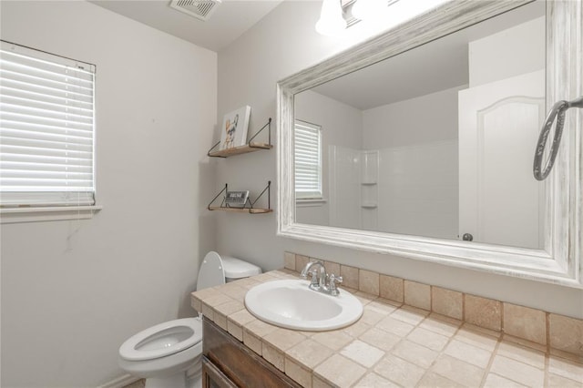 2504 NW 180th St, Edmond, OK 73012 - bathroom featuring toilet, vanity, and a shower