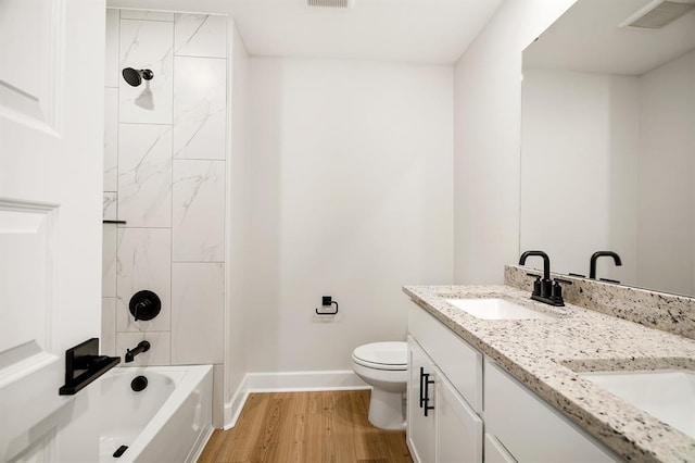 11904 SW 30th St, Yukon, OK 73099 - bathroom featuring baseboards, wood finished floors, toilet, double vanity, and  shower combination