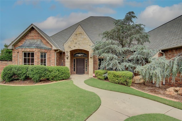 12509 St Lukes Ln, Oklahoma City, OK 73142 - tudor home with stone siding, a front yard, and brick siding