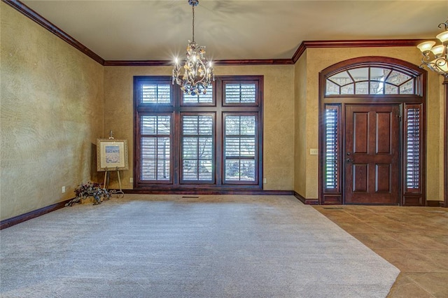 12509 St Lukes Ln, Oklahoma City, OK 73142 - foyer entrance featuring a chandelier, ornamental molding, tile patterned floors, baseboards, and a textured wall