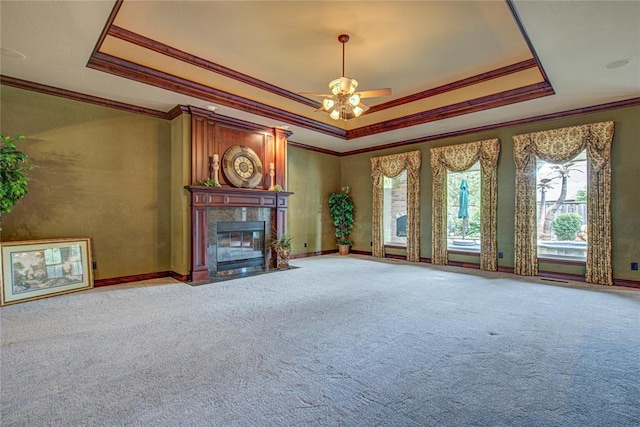 12509 St Lukes Ln, Oklahoma City, OK 73142 - unfurnished living room with ornamental molding, a tray ceiling, a high end fireplace, ceiling fan, and carpet floors
