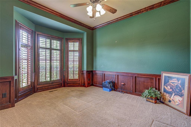 12509 St Lukes Ln, Oklahoma City, OK 73142 - carpeted empty room featuring healthy amount of natural light, a ceiling fan, wainscoting, and ornamental molding