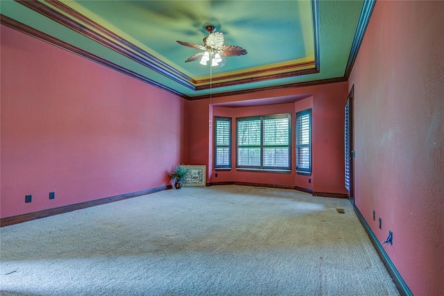 12509 St Lukes Ln, Oklahoma City, OK 73142 - empty room featuring ornamental molding, carpet flooring, a tray ceiling, ceiling fan, and baseboards