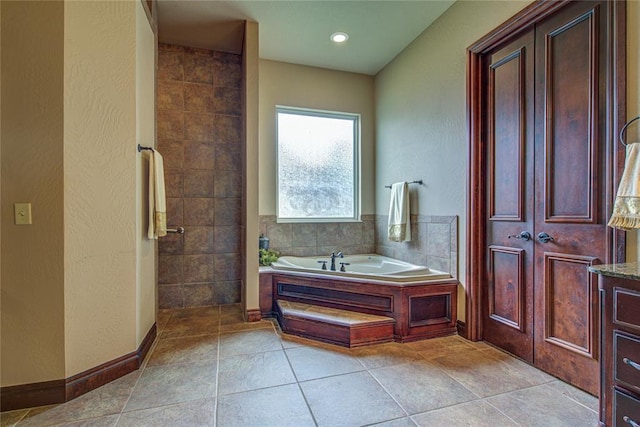 12509 St Lukes Ln, Oklahoma City, OK 73142 - bathroom featuring a bath, a textured wall, and tile patterned flooring