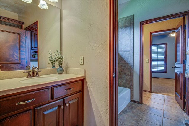 12509 St Lukes Ln, Oklahoma City, OK 73142 - full bathroom featuring vanity, a textured wall, tile patterned flooring, and baseboards