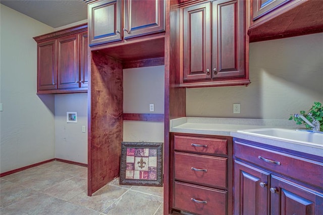 12509 St Lukes Ln, Oklahoma City, OK 73142 - kitchen with a sink, light countertops, dark brown cabinets, and baseboards