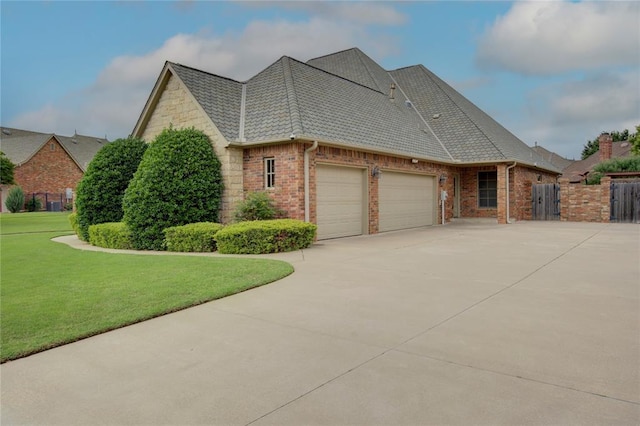12509 St Lukes Ln, Oklahoma City, OK 73142 - view of side of property with a garage, driveway, and brick siding