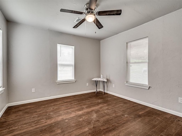 spare room with wood finished floors, ceiling fan, and baseboards
