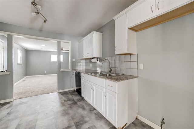 2109 Brighton Ave, Oklahoma City, OK 73120 - kitchen featuring dishwasher, a sink, a ceiling fan, white cabinetry, and baseboards