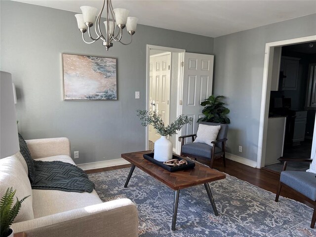 2109 Brighton Ave, Oklahoma City, OK 73120 - living room featuring wood finished floors, baseboards, and a chandelier