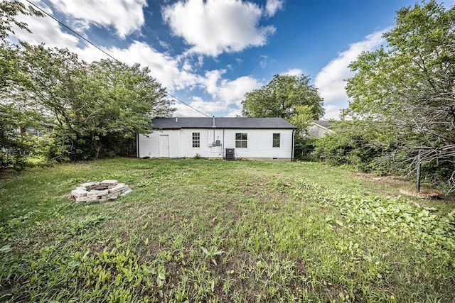 3134 NW Ferris Ave, Lawton, OK 73505 - rear view of house with a fire pit, crawl space, a yard, and central air condition unit