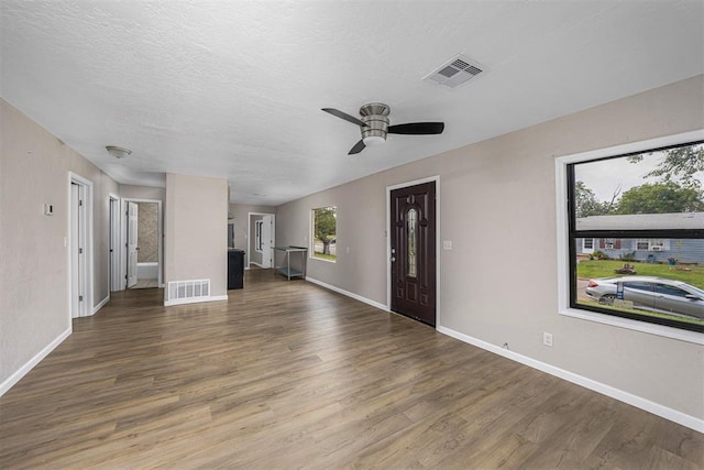 3134 NW Ferris Ave, Lawton, OK 73505 - unfurnished living room with baseboards, wood finished floors, and a ceiling fan