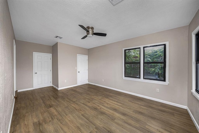 3134 NW Ferris Ave, Lawton, OK 73505 - unfurnished bedroom with wood finished floors, baseboards, a textured ceiling, and a ceiling fan