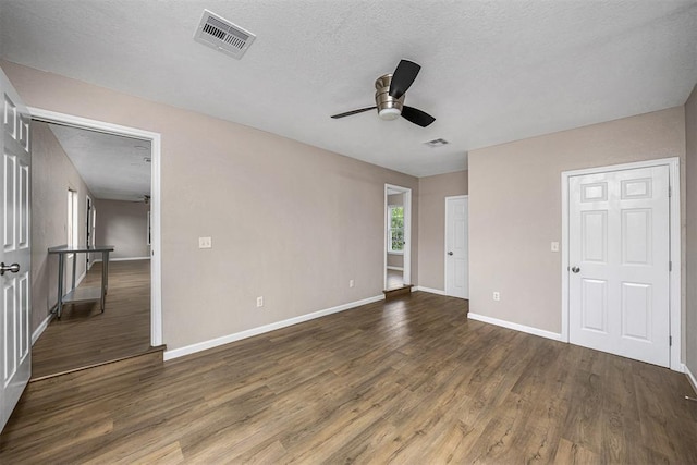 3134 NW Ferris Ave, Lawton, OK 73505 - unfurnished bedroom with wood finished floors, baseboards, ceiling fan, and a textured ceiling