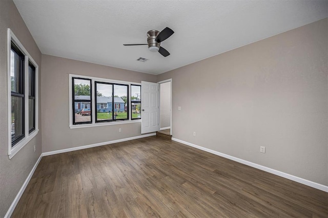 3134 NW Ferris Ave, Lawton, OK 73505 - empty room with a ceiling fan, baseboards, and dark wood-style flooring