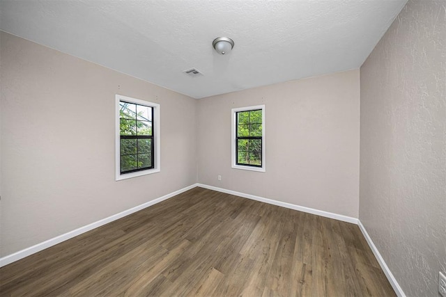 3134 NW Ferris Ave, Lawton, OK 73505 - empty room with plenty of natural light, wood finished floors, and baseboards