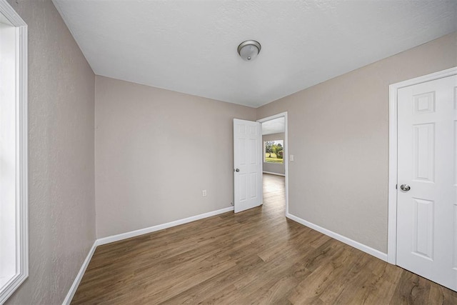 3134 NW Ferris Ave, Lawton, OK 73505 - empty room featuring wood finished floors and baseboards