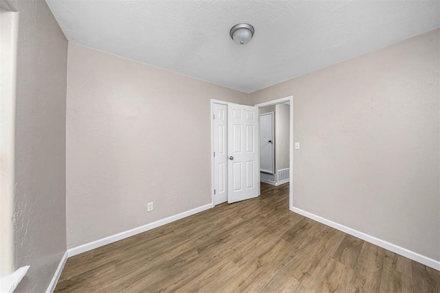 3134 NW Ferris Ave, Lawton, OK 73505 - empty room featuring baseboards and wood finished floors