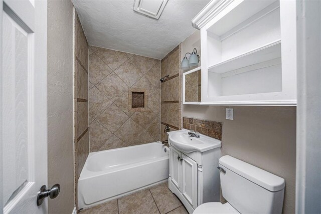 3134 NW Ferris Ave, Lawton, OK 73505 - full bathroom featuring toilet, vanity, shower / bath combination, tile patterned floors, and a textured ceiling